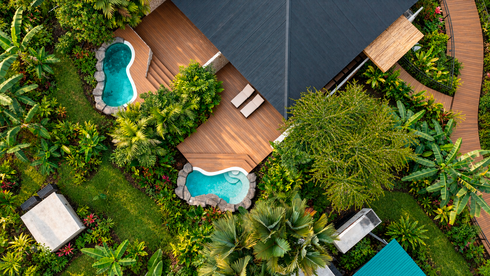 Aerial view of Arenal Rainforest Resort, with private pools and tropical gardens.