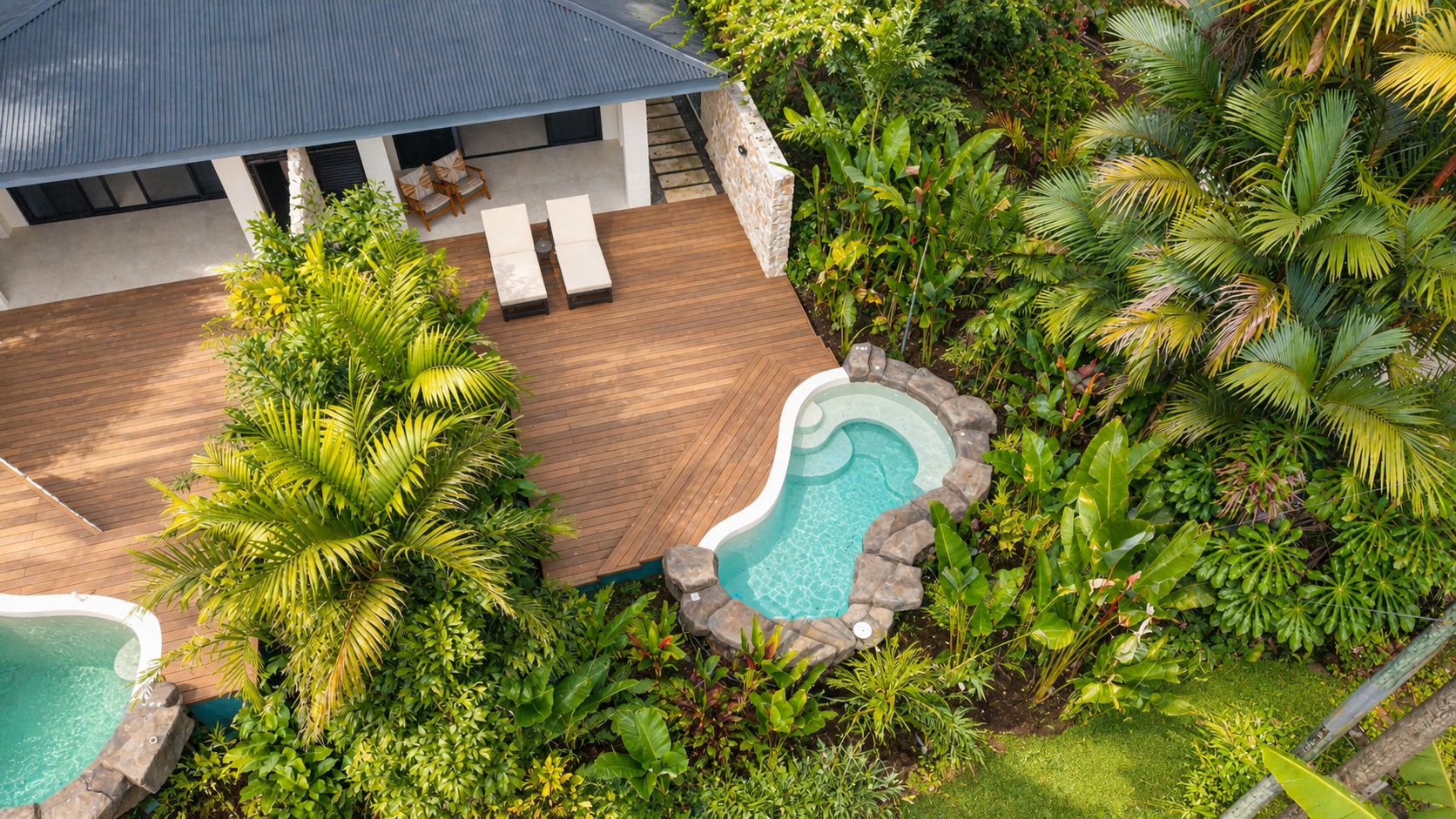 Aerial view of Arenal Rainforest Resort terraces, private pools and tropical gardens